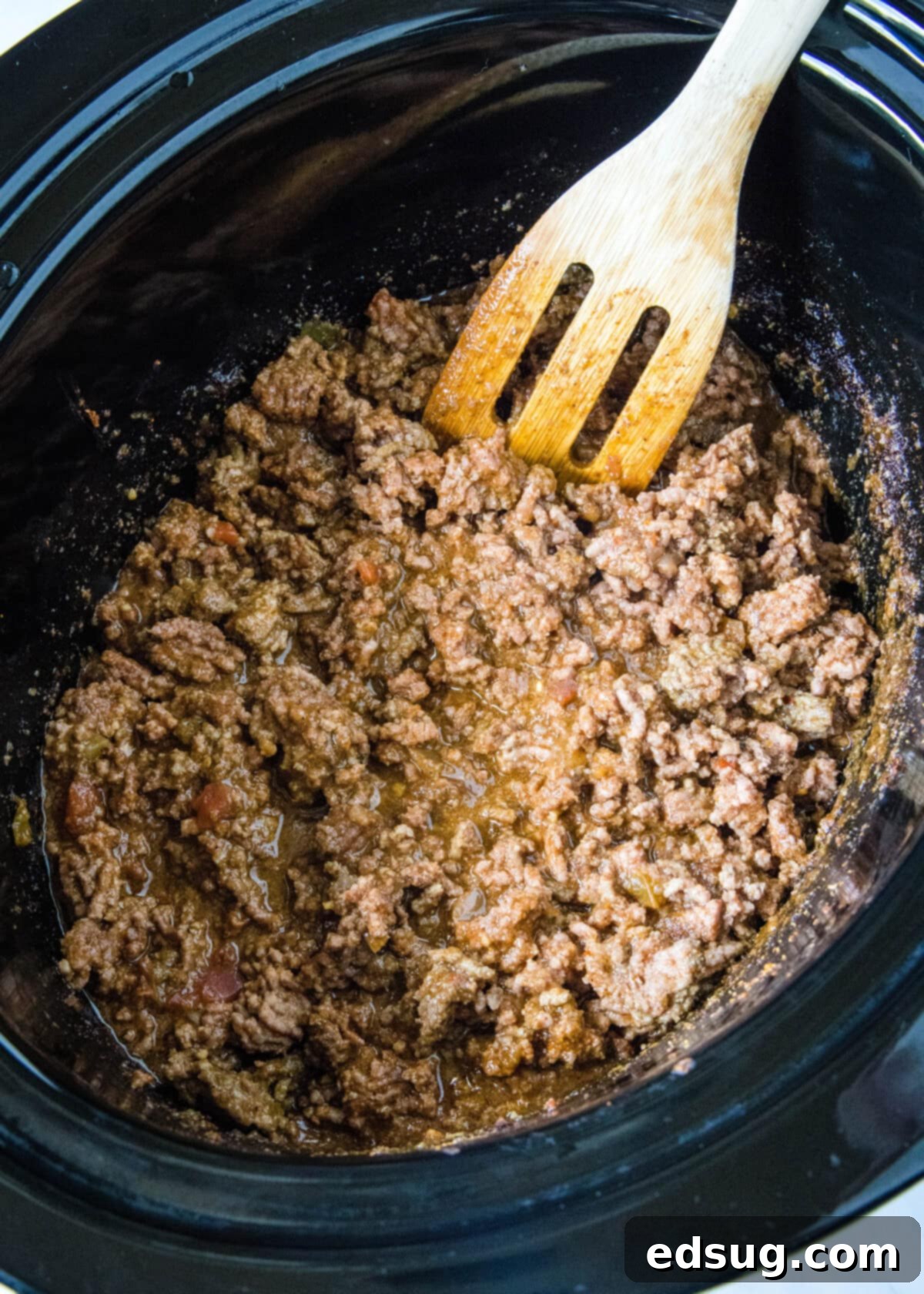 This slow cooker taco meat is an easy, 3-ingredient crock pot recipe that's packed with flavor. Perfect for parties and busy weeknights! Browned ground beef taco meat simmering in the slow cooker, absorbing all the delicious flavors.
