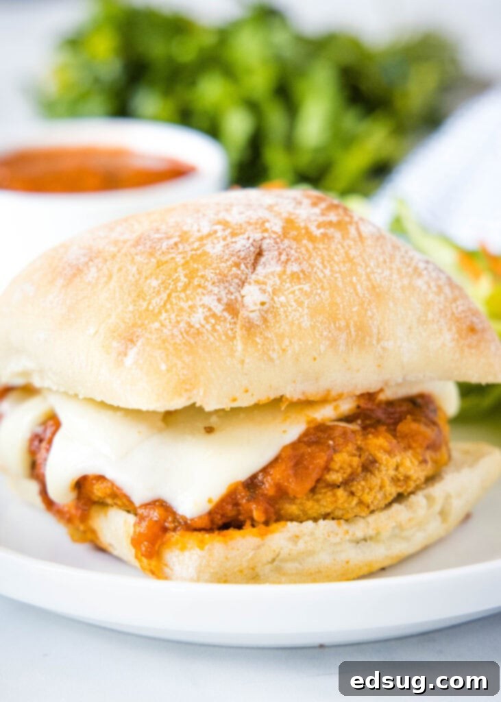 Crispy chicken parmesan sandwich with marinara and melted cheese