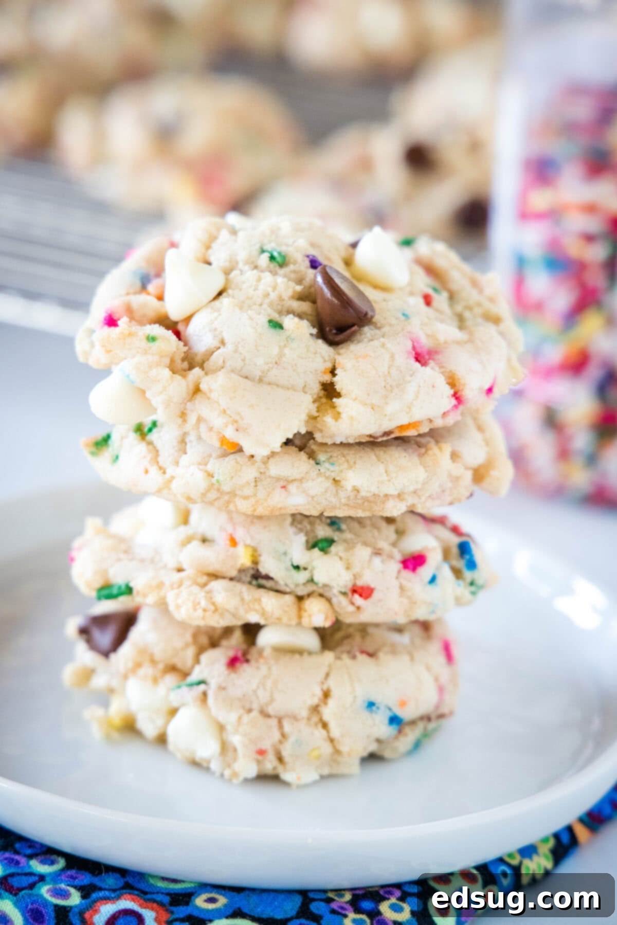 Dreamy Cake Batter Cookies 2 cake batter cookies stacked on a white plate, showcasing their thick, soft texture and colorful sprinkles