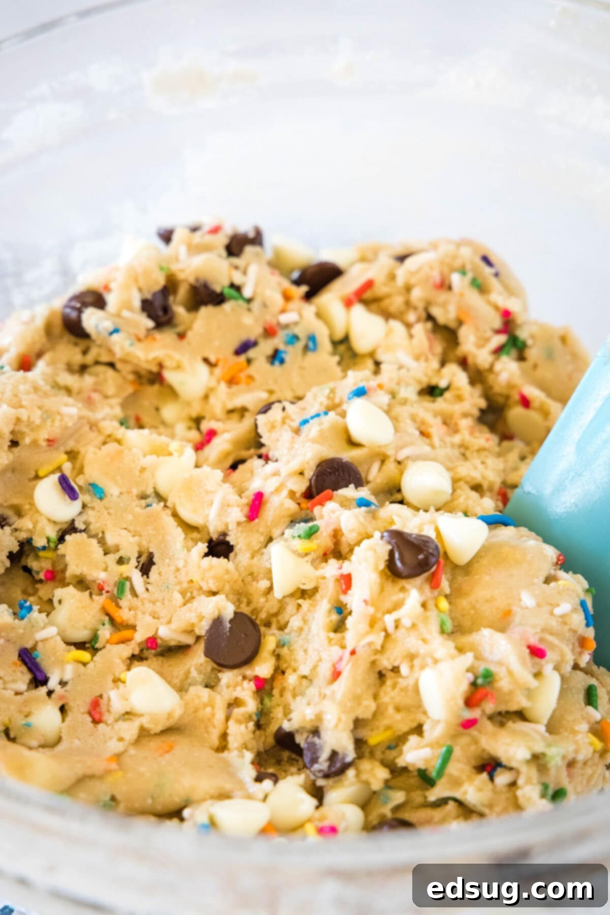Dreamy Cake Batter Cookies 4 cake batter cookie dough in a mixing bowl, featuring colorful sprinkles and chocolate chips