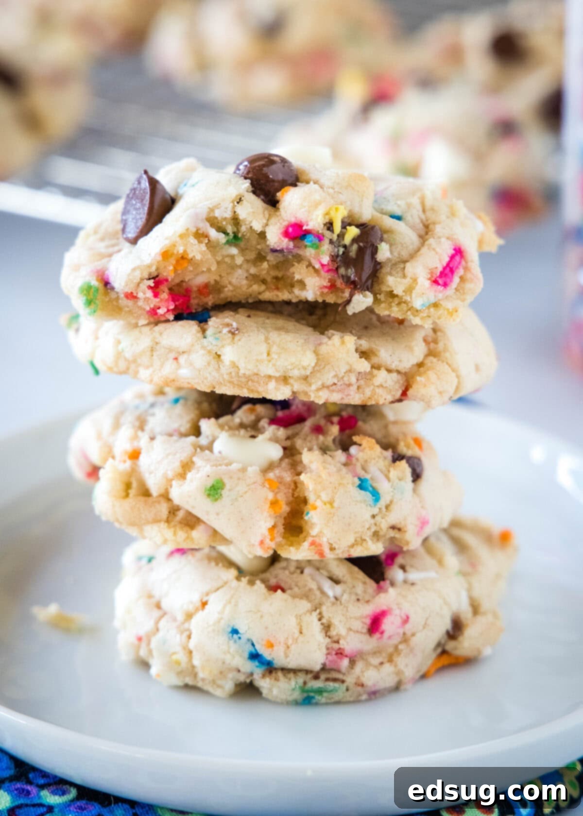 Dreamy Cake Batter Cookies 6 stacked cake batter cookies with a bite taken out of one, revealing the soft interior and sprinkles