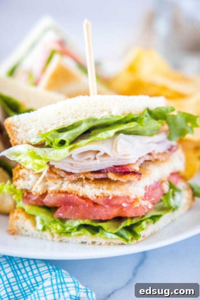 Ultimate Turkey Club Sandwich 2 close up of turkey club sandwich on a plate