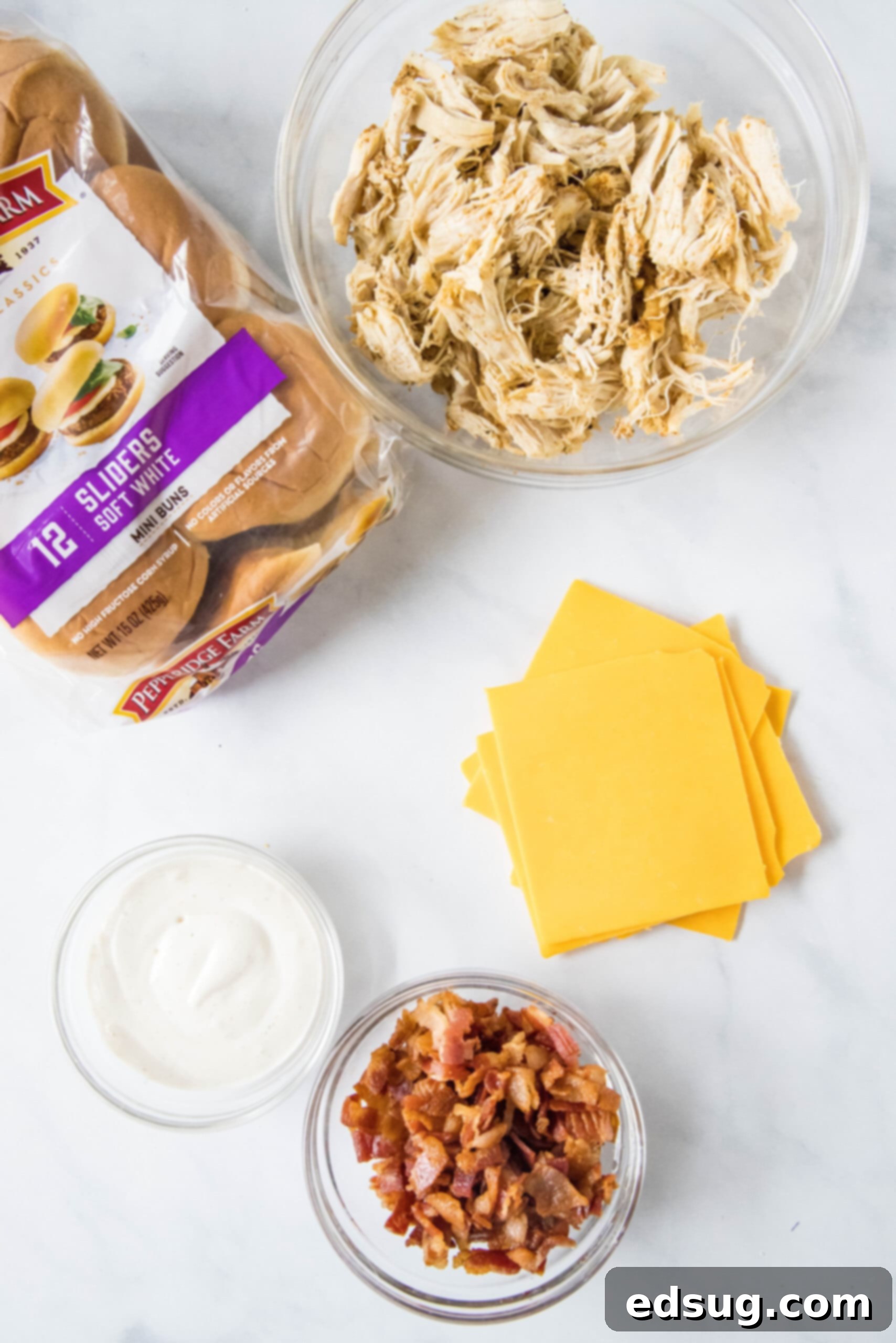 Make my easy chicken bacon ranch sliders with juicy shredded chicken, bacon, and creamy ranch dressing between sweet, fluffy Hawaiian rolls! Ingredients for chicken bacon ranch sliders.