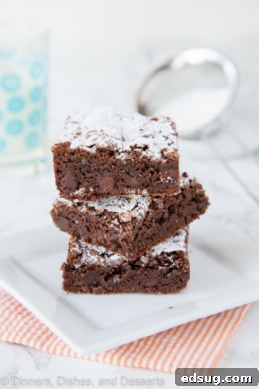 Decadent Nutella Fudge Brownies 3 nutella brownies stacked on a plate