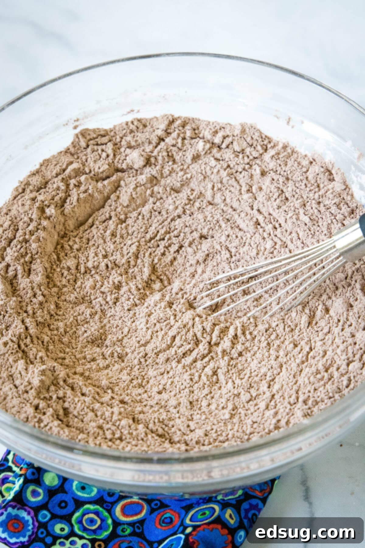 Homemade hot chocolate mix whisked together in a glass bowl.
