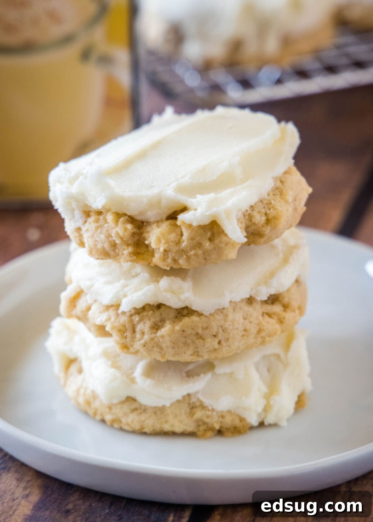 Festive Eggnog Cookies 2 stack of eggnog cookies on a white plate, showcasing their thick, soft texture and festive frosting.