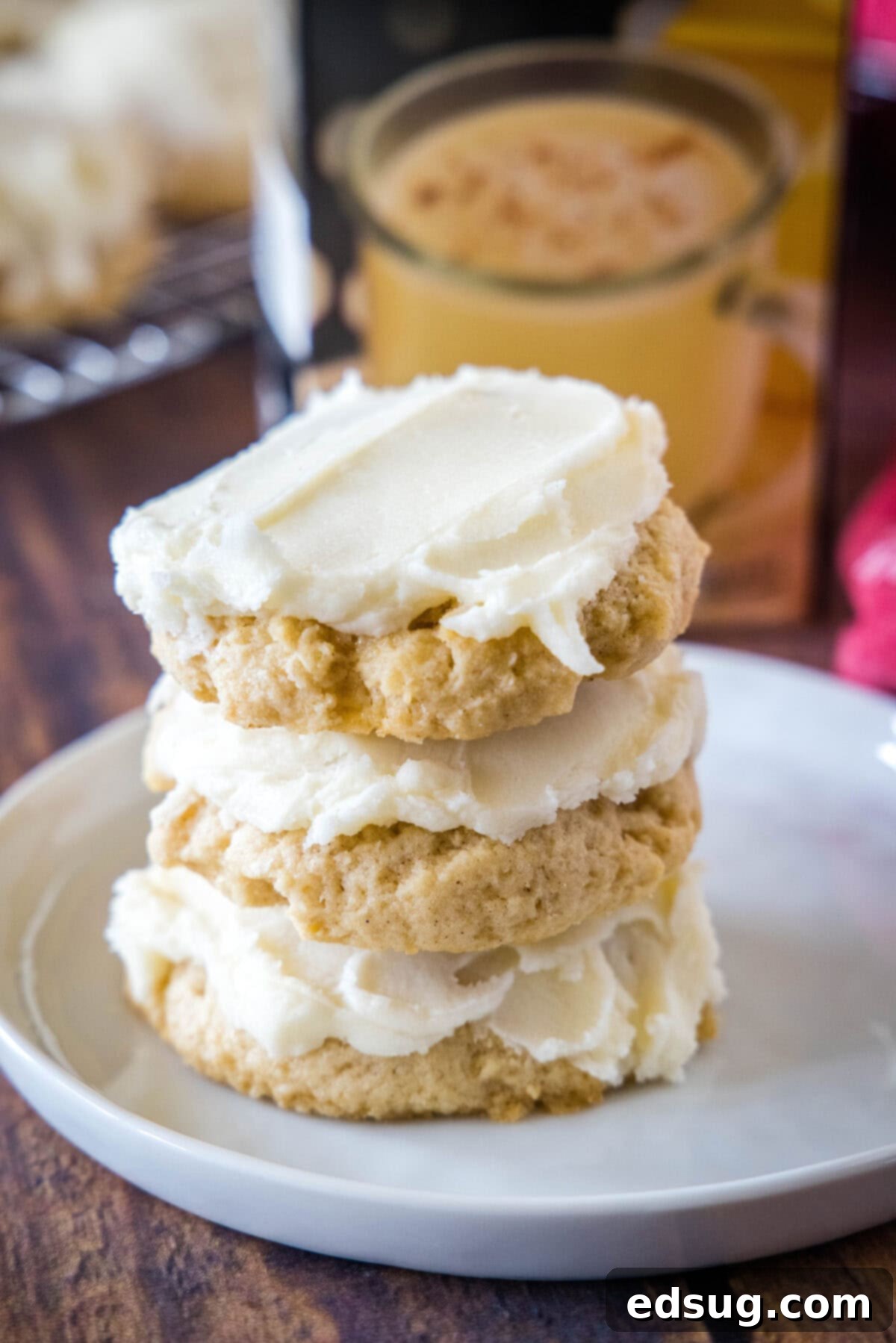 Festive Eggnog Cookies 7 stack of eggnog sugar cookies on a white plate, ready for serving.