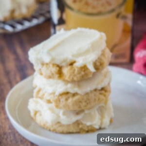 Festive Eggnog Cookies 8 close up stacked eggnog sugar cookies on a white plate