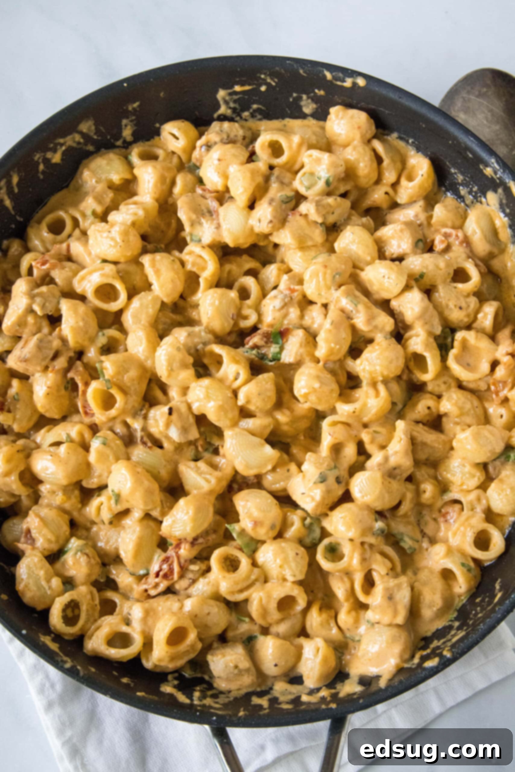 Flavor-packed Marry Me Chicken pasta is a 30-minute, one-pan weeknight dinner with tender pasta and chicken in creamy sun-dried tomato sauce. Overhead view of Marry Me Chicken pasta in a skillet.