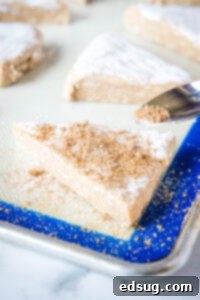 sprinkling cinnamon and sugar over scones