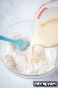pouring heavy cream into flour mixture