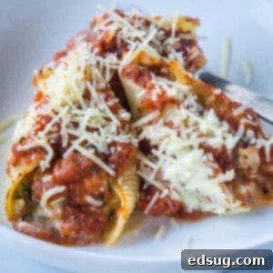 cropped close up spinach stuffed shells on a white plate