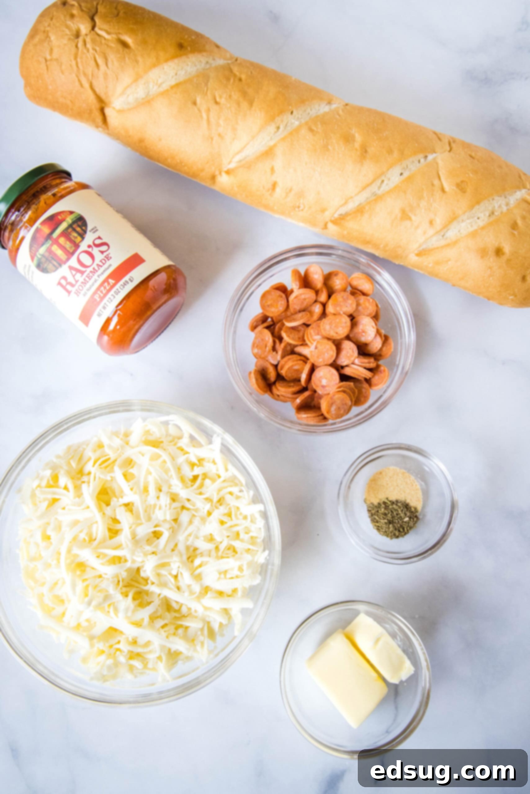 Gather your ingredients for this easy French bread pizza recipe: zesty garlic butter components, savory pizza sauce, melty mozzarella, and your choice of fresh toppings! A collection of fresh ingredients laid out for French bread pizza, including bread, sauce, cheese, butter, and seasonings.