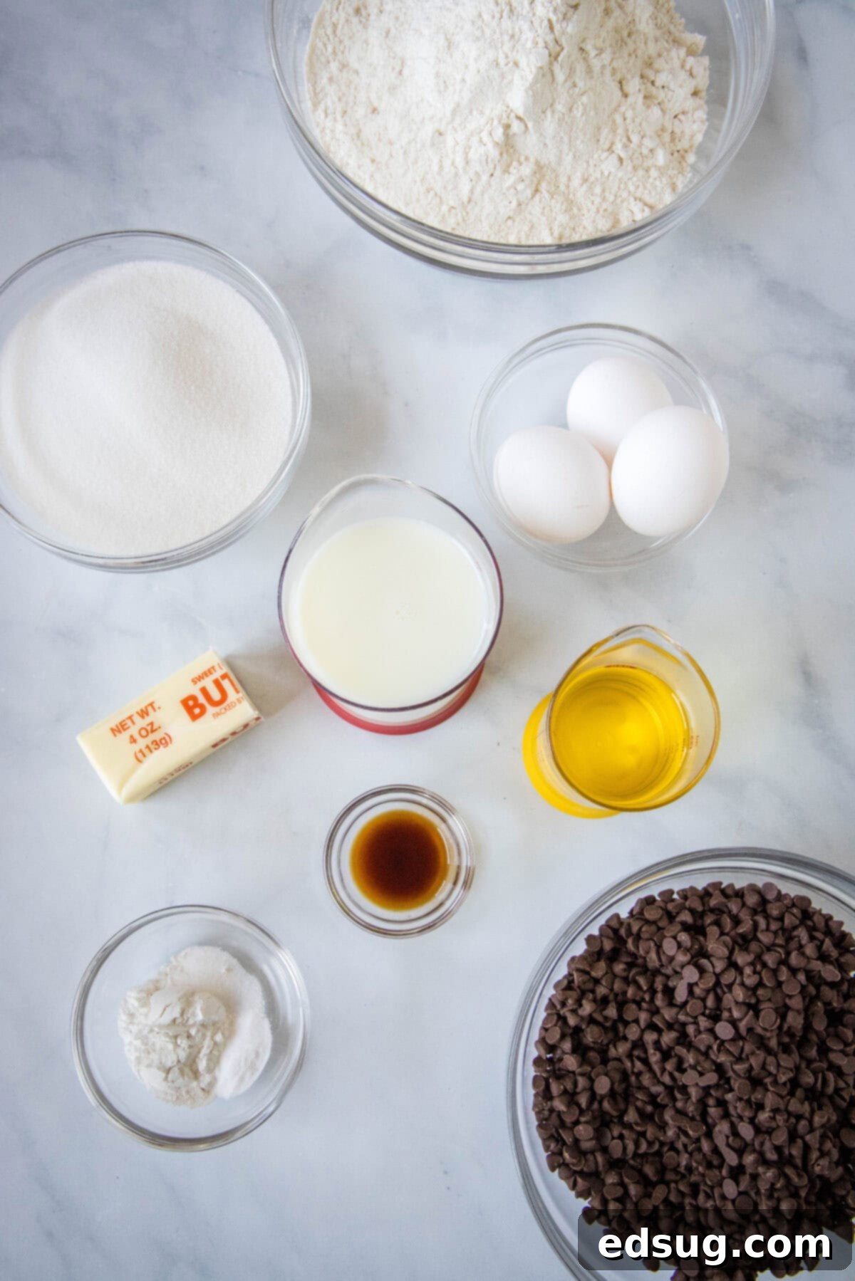 Signature Bakery Chocolate Chip Muffins 4 ingredients for chocolate chip muffins laid out on a counter