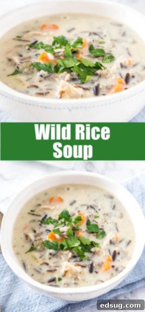 A bowl of creamy wild rice soup in a white bowl, garnished with fresh herbs and a wooden spoon.