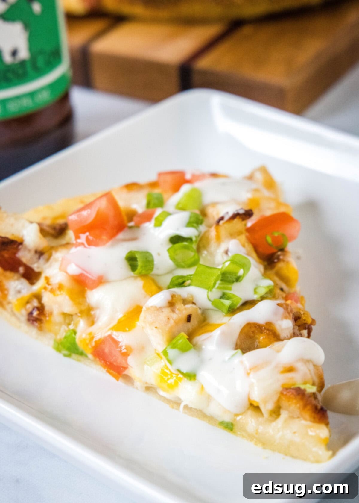 chicken bacon ranch pizza on a white plate