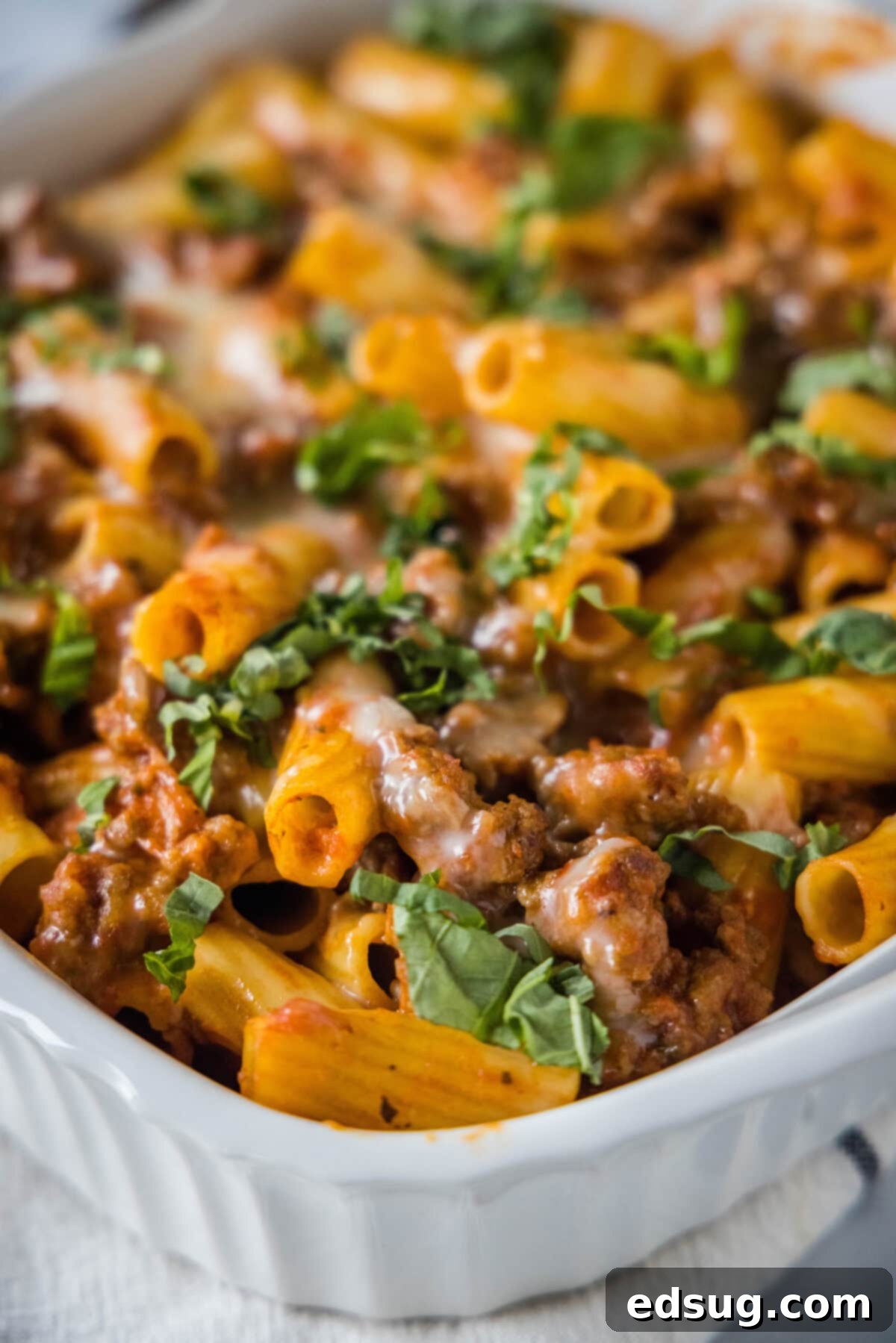 Hearty Italian Sausage Bake 2 baking dish with sausage casserole topped with fresh basil