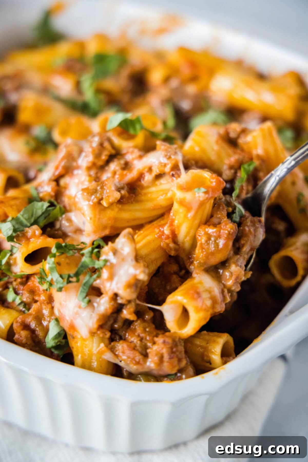 Hearty Italian Sausage Bake 5 scooping italian sausage casserole out of baking dish