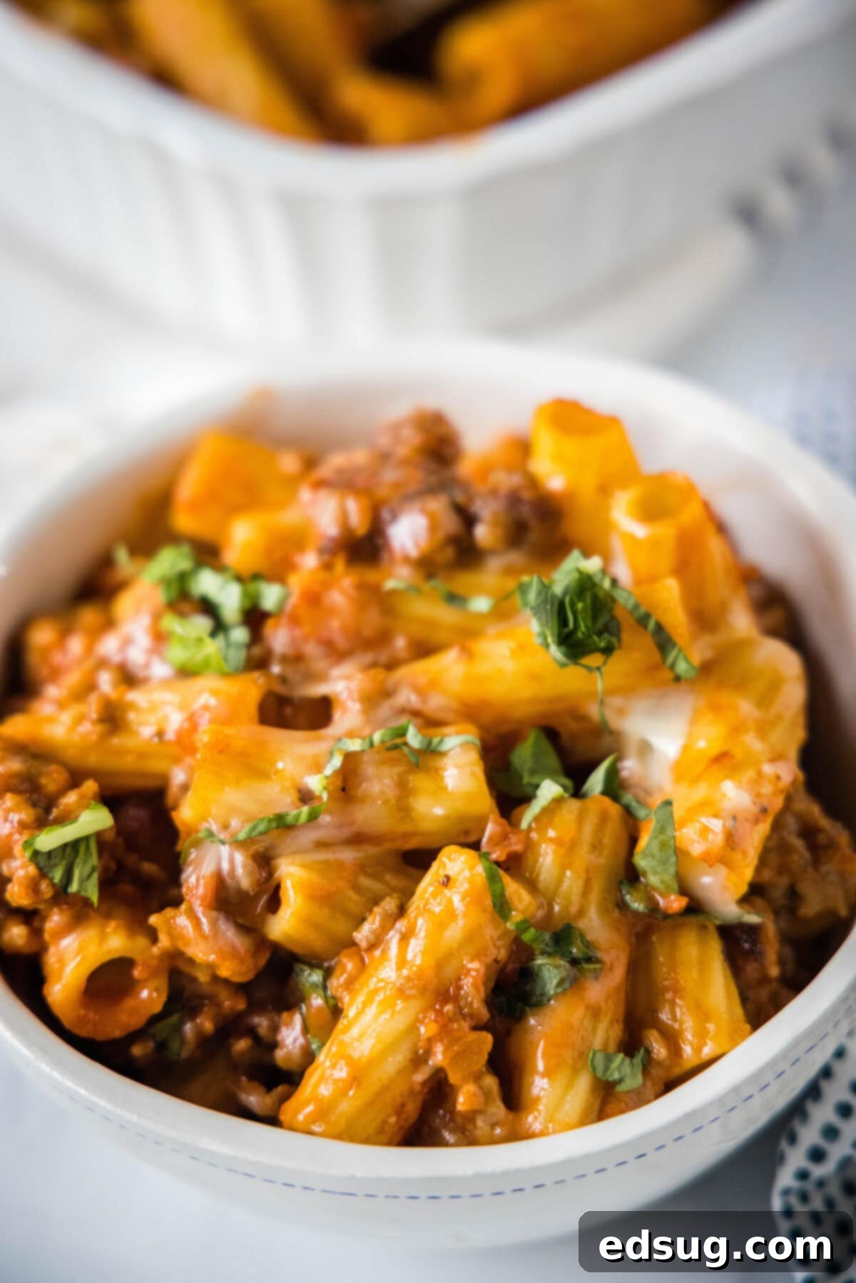 Hearty Italian Sausage Bake 6 italian sausage casserole in a bowl with fresh basil