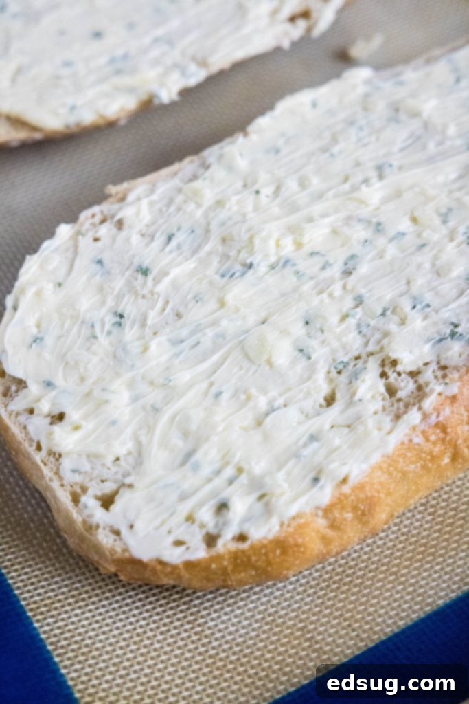 Buttery Garlic Bliss 4 spreading garlic butter mixture evenly onto a halved loaf of bread