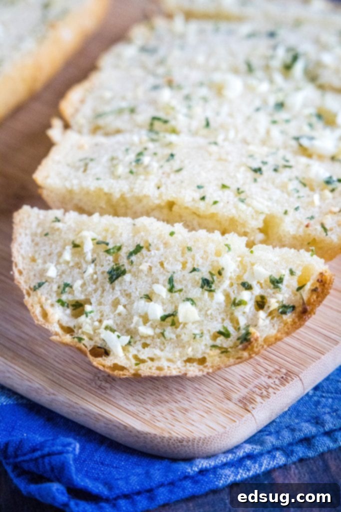 Buttery Garlic Bliss 5 freshly baked garlic bread on a cutting board, cut into perfect slices