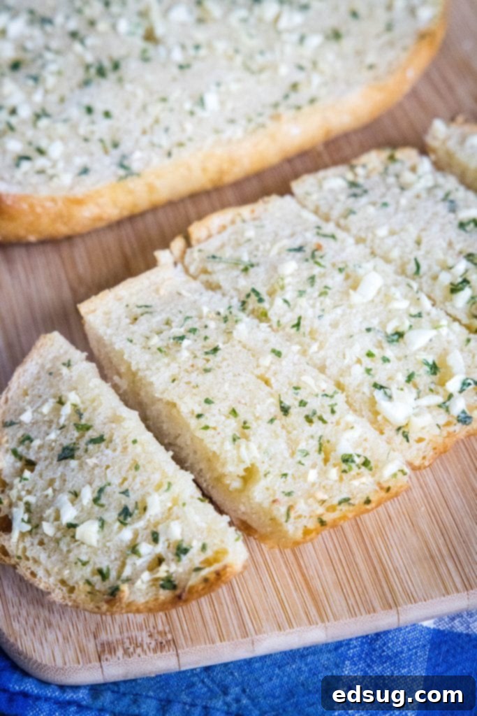 Buttery Garlic Bliss 6 close-up of freshly baked garlic bread slices on a wooden cutting board