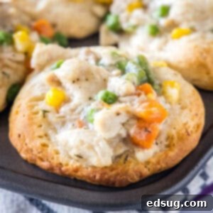Chicken Pot Pie Bites 2 Close up of a mini chicken pot pie in a muffin tin, highlighting the golden-brown crust and inviting filling.