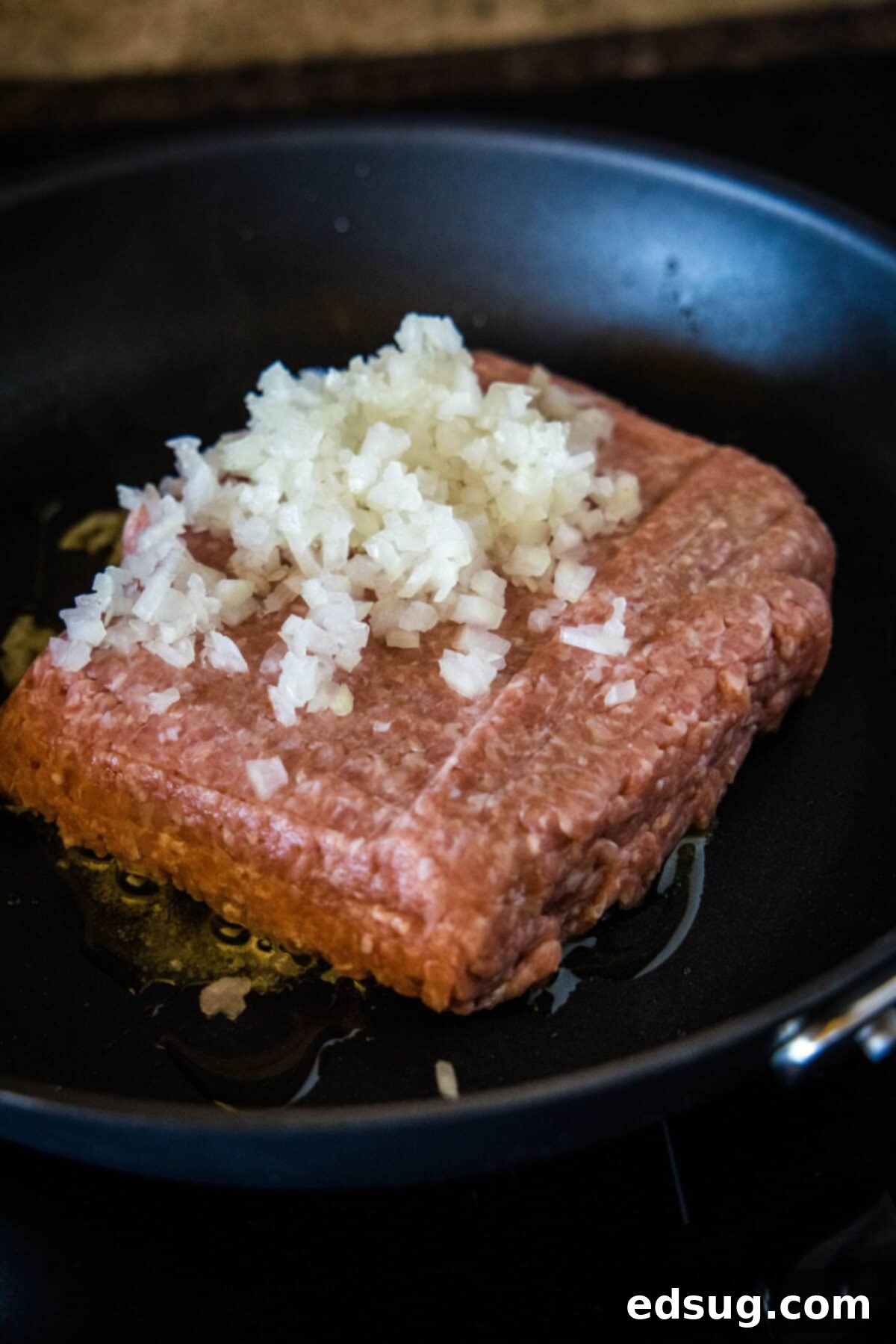 Easy ground turkey Sloppy Joes made with juicy turkey instead of ground beef, cooked in one pan with a rich, flavor-packed homemade sauce! Diced onions added to ground turkey in a skillet, browning together.