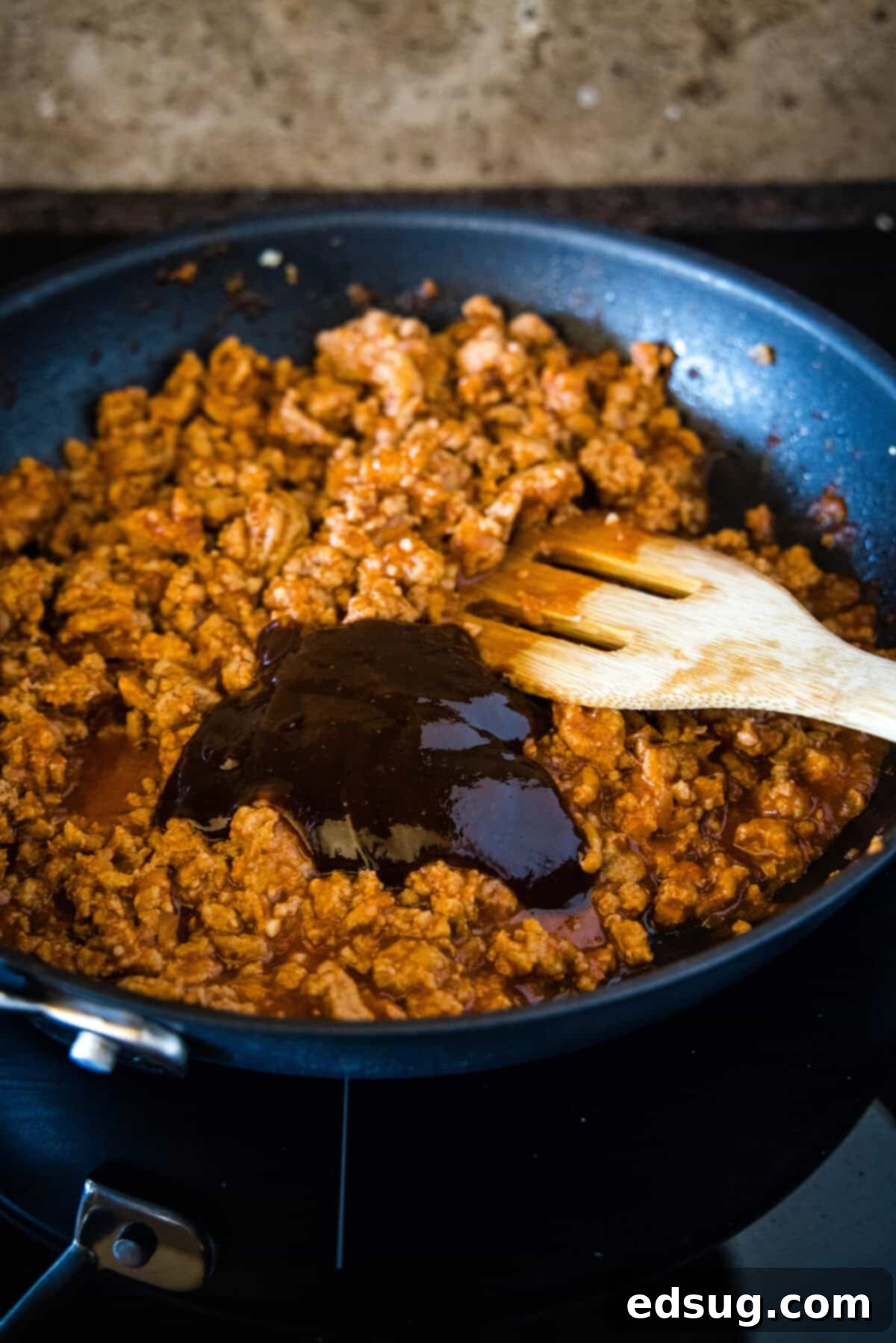 Easy ground turkey Sloppy Joes made with juicy turkey instead of ground beef, cooked in one pan with a rich, flavor-packed homemade sauce! BBQ sauce added to seasoned ground turkey in a skillet, stirring to combine.