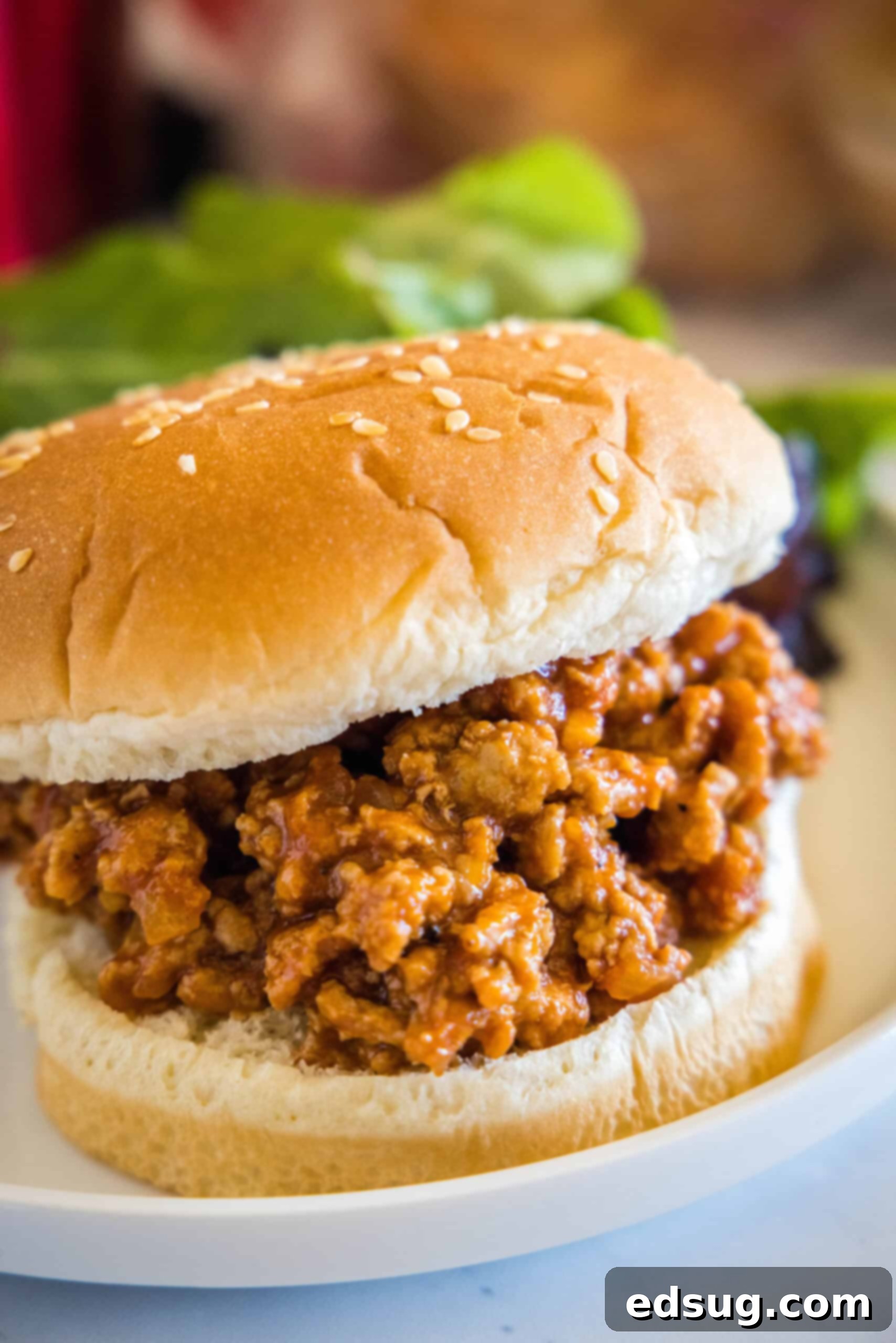 Easy ground turkey Sloppy Joes made with juicy turkey instead of ground beef, cooked in one pan with a rich, flavor-packed homemade sauce! Close up of a turkey sloppy joes sandwich on a plate, showing the rich, thick sauce.