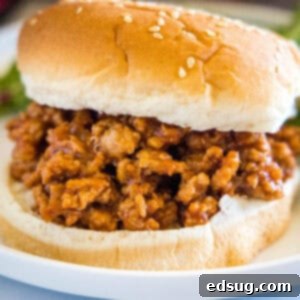 Hearty Ground Turkey Sloppy Joes 2 Close up of a ground turkey sloppy joes sandwich on a plate.