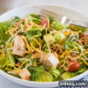Zesty BBQ Chicken Salad 2 BBQ chicken salad in a white bowl with a fork.