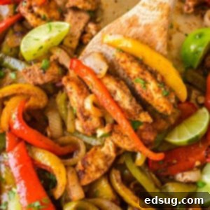 cropped close up chicken fajitas on a sheet pan