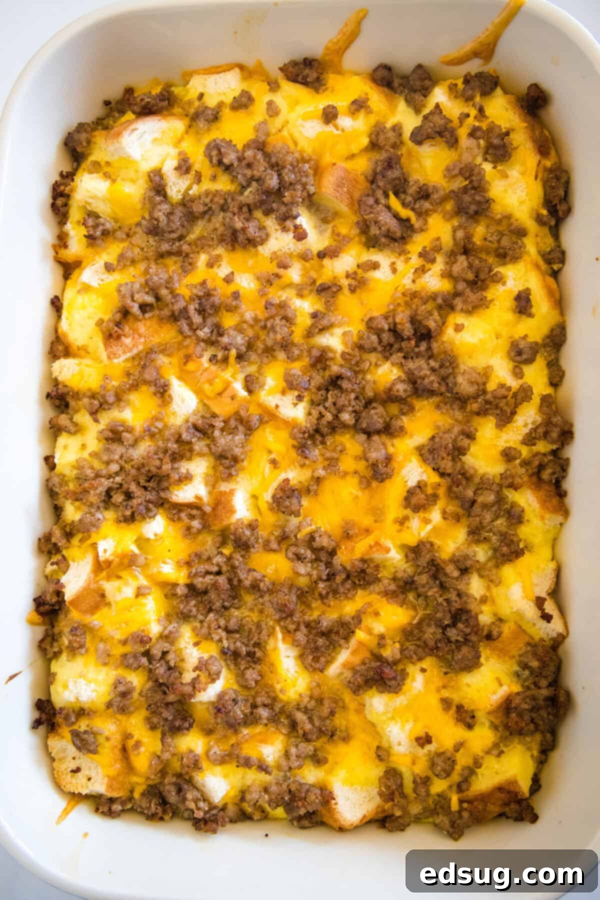 This sourdough breakfast casserole is the ultimate make-ahead breakfast packed with sourdough bread chunks, breakfast sausage, and cheese! The baked sourdough breakfast casserole, golden brown and bubbling, fresh from the oven and ready to serve.