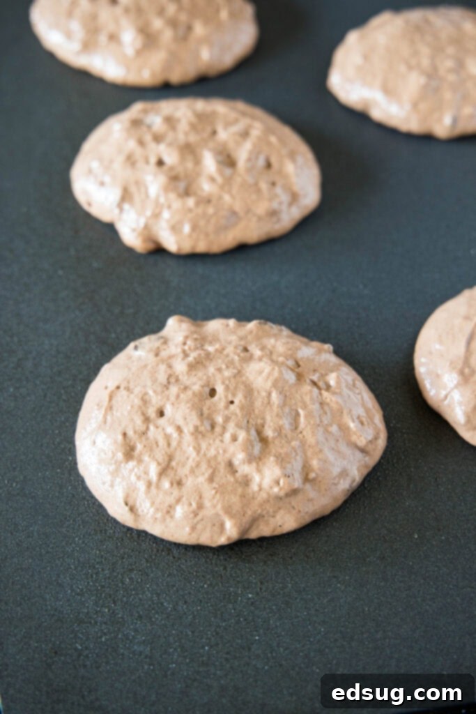 Irresistible Chocolate Pancakes 5 pancakes cooking on the griddle