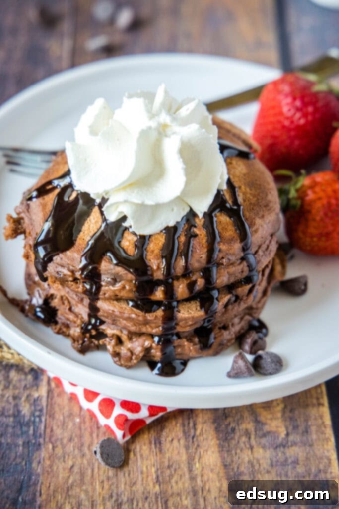 Irresistible Chocolate Pancakes 7 looking down on chocolate pancakes topped with whipped cream