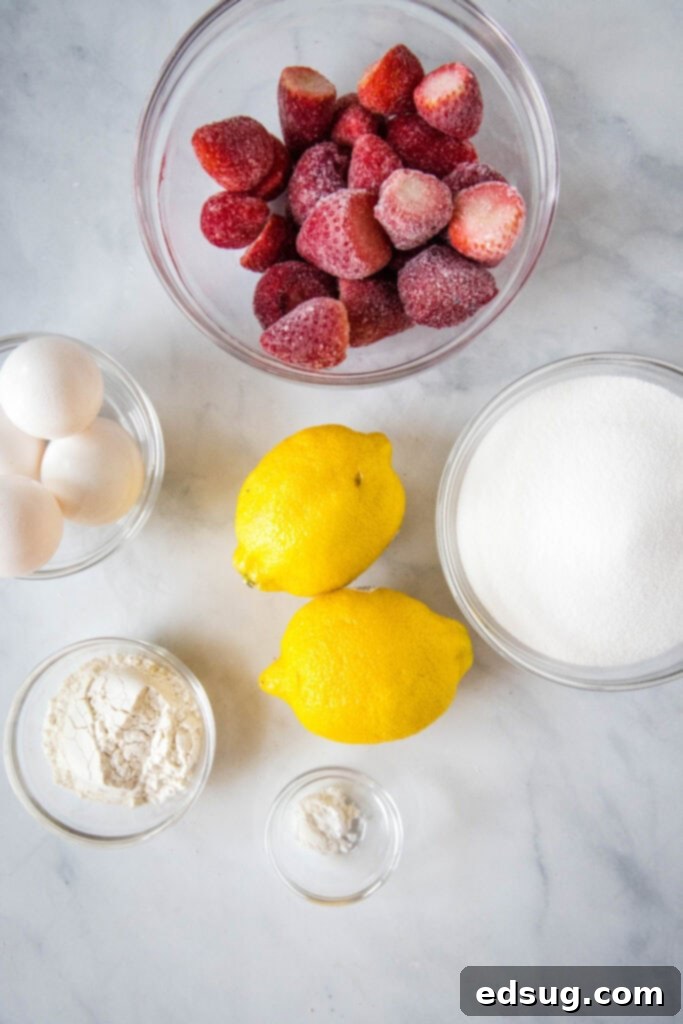 Bright & Tangy Strawberry Lemonade Treats 3 All the essential ingredients for making delicious strawberry lemon bars laid out on a kitchen counter.