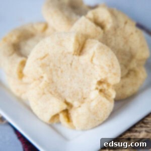 Close up of several Angel Crisp Cookies on a plate, showing their delightful texture and sugar coating.