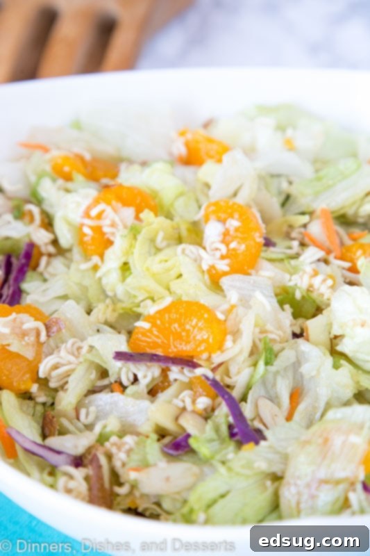 Far East Crunch Salad 4 A bowl of food on a plate, with Salad and Dinner