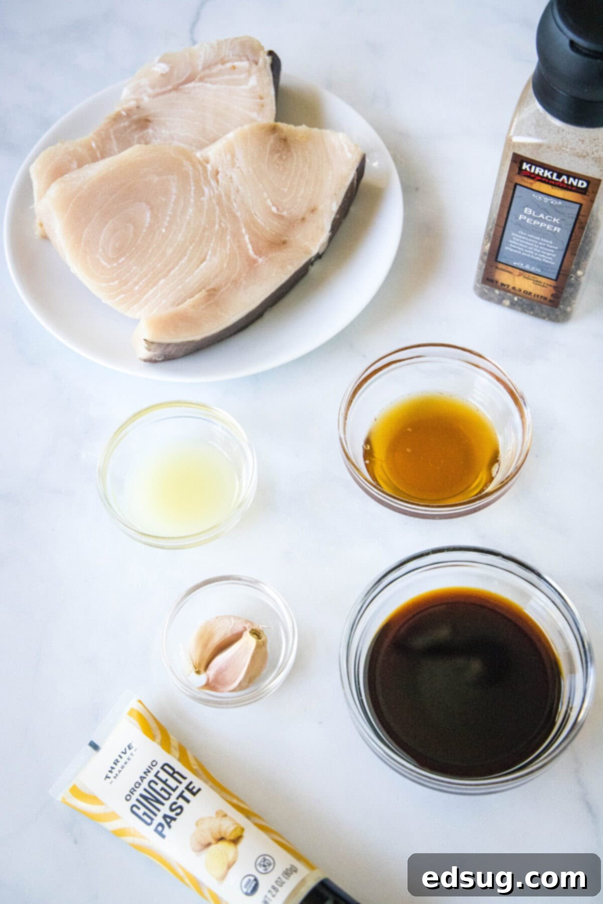 Ingredients for grilled swordfish marinade laid out on a cutting board