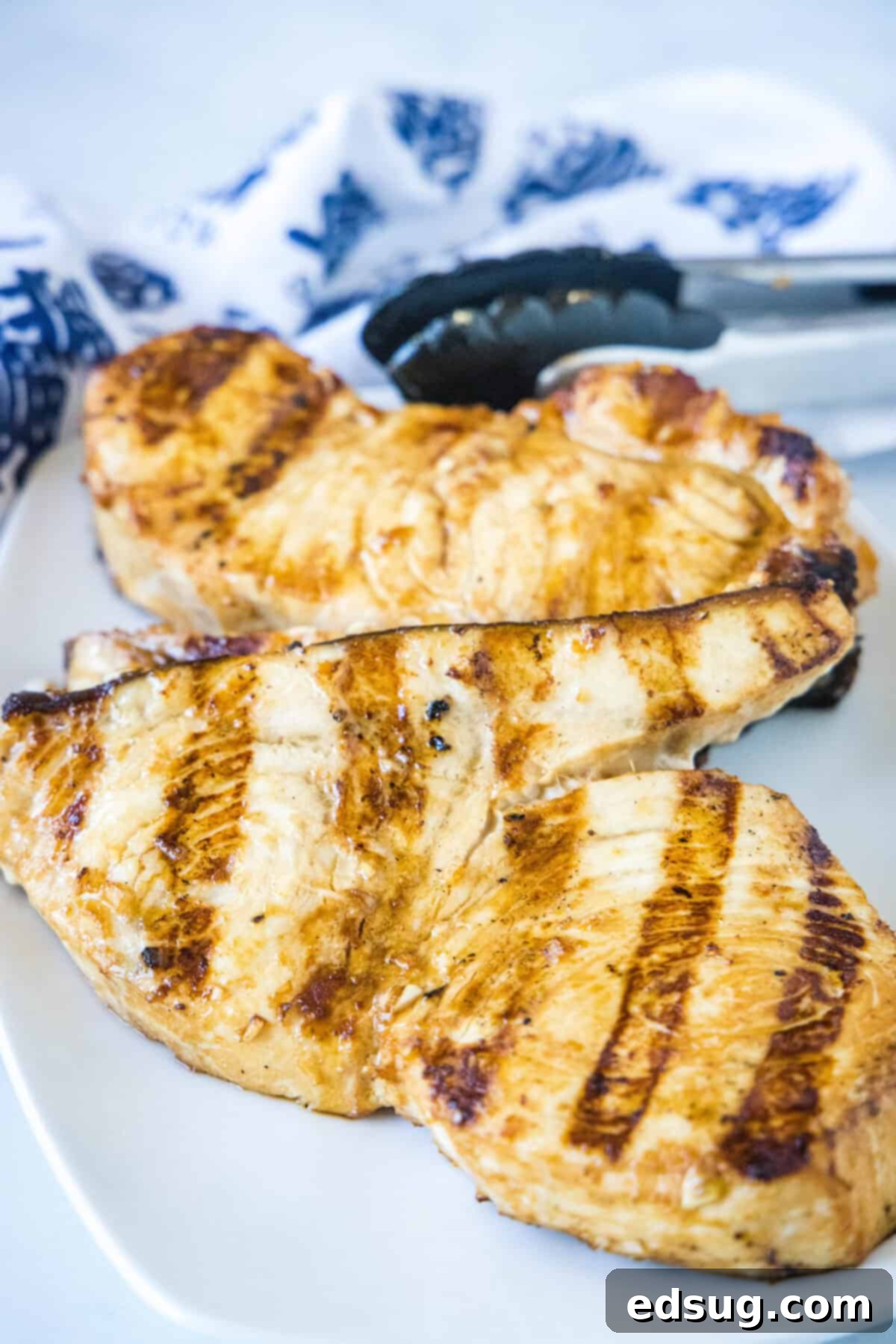 Cooked grilled swordfish steak on a white serving plate