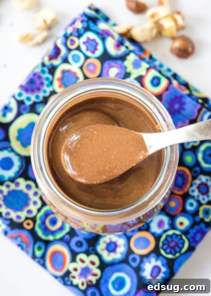Homemade Chocolate Hazelnut Spread 6 a jar with nutella and a spoon in it, showcasing the rich color