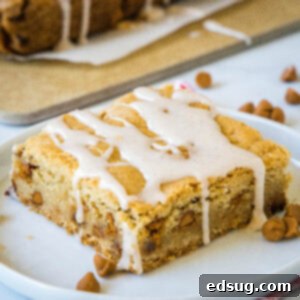 Cozy Cinnamon Blondies 8 Close-up of a perfectly baked Cinnamon Blondie on a plate, showing its soft interior and cinnamon chips.