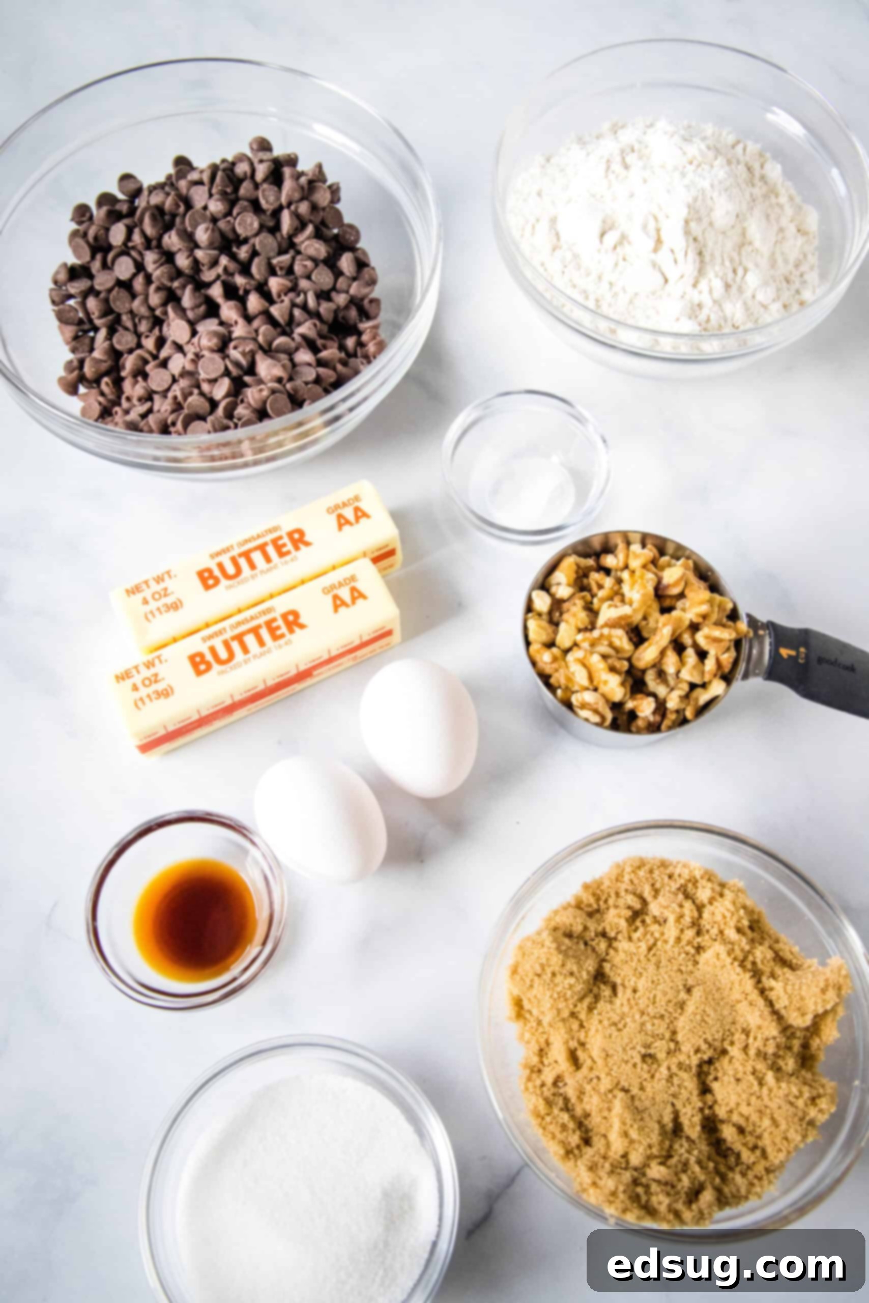 Congo bars are thick and gooey cookie bars loaded with two types of chocolate and crunchy walnuts. Make them in one bowl in minutes! Various ingredients for Congo bars laid out on a surface.