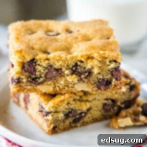 Golden Chocolate Chip Bars 2 Two Congo bars stacked on a white plate, ready to be enjoyed.