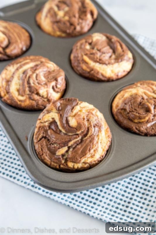 Decadent Nutella Muffins 3 nutella muffins in a muffin tin