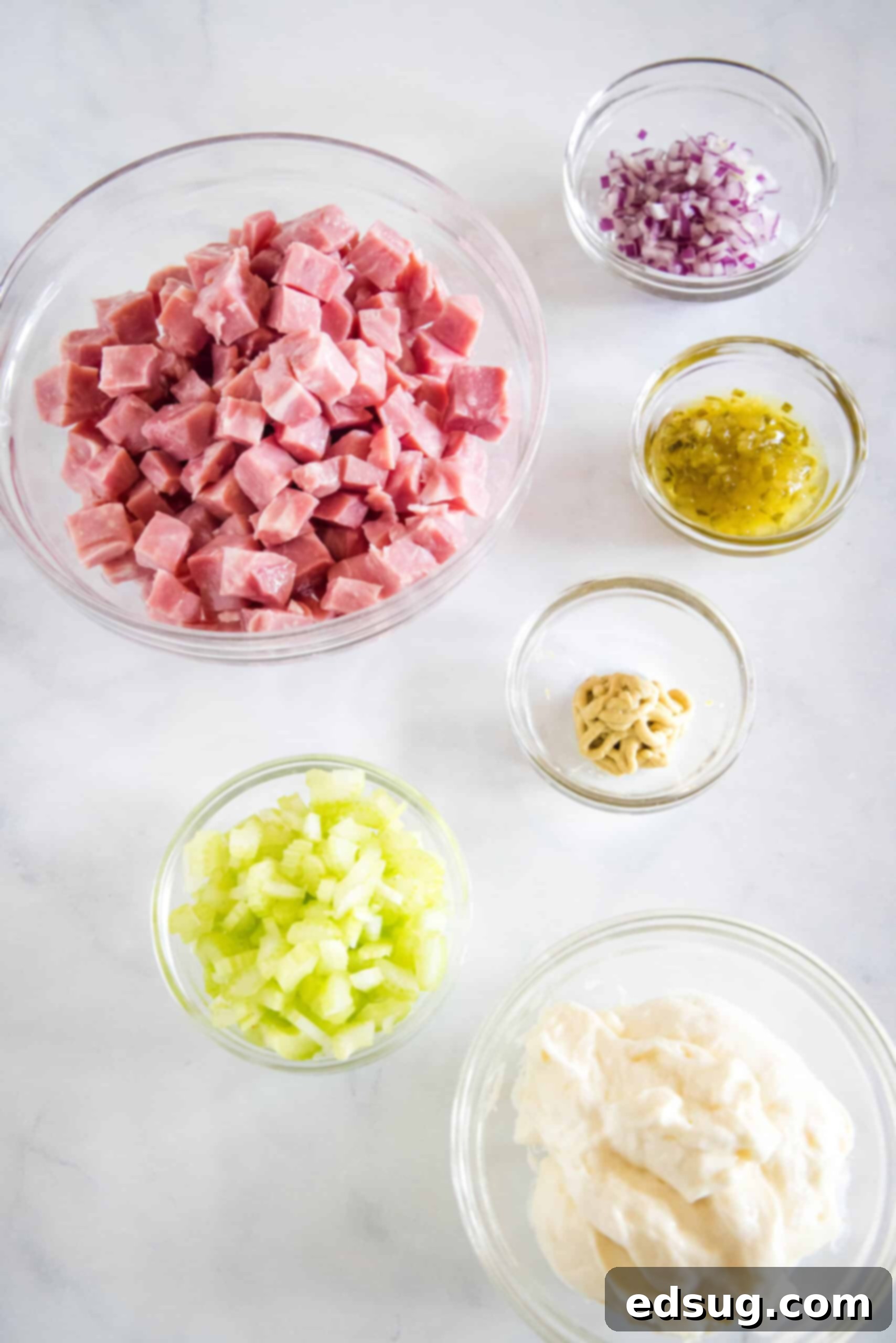 This ham salad recipe is the best way to use up leftover ham! It's similar to a chicken salad, with mayo, red onions, and juicy shredded ham. Ham salad ingredients.