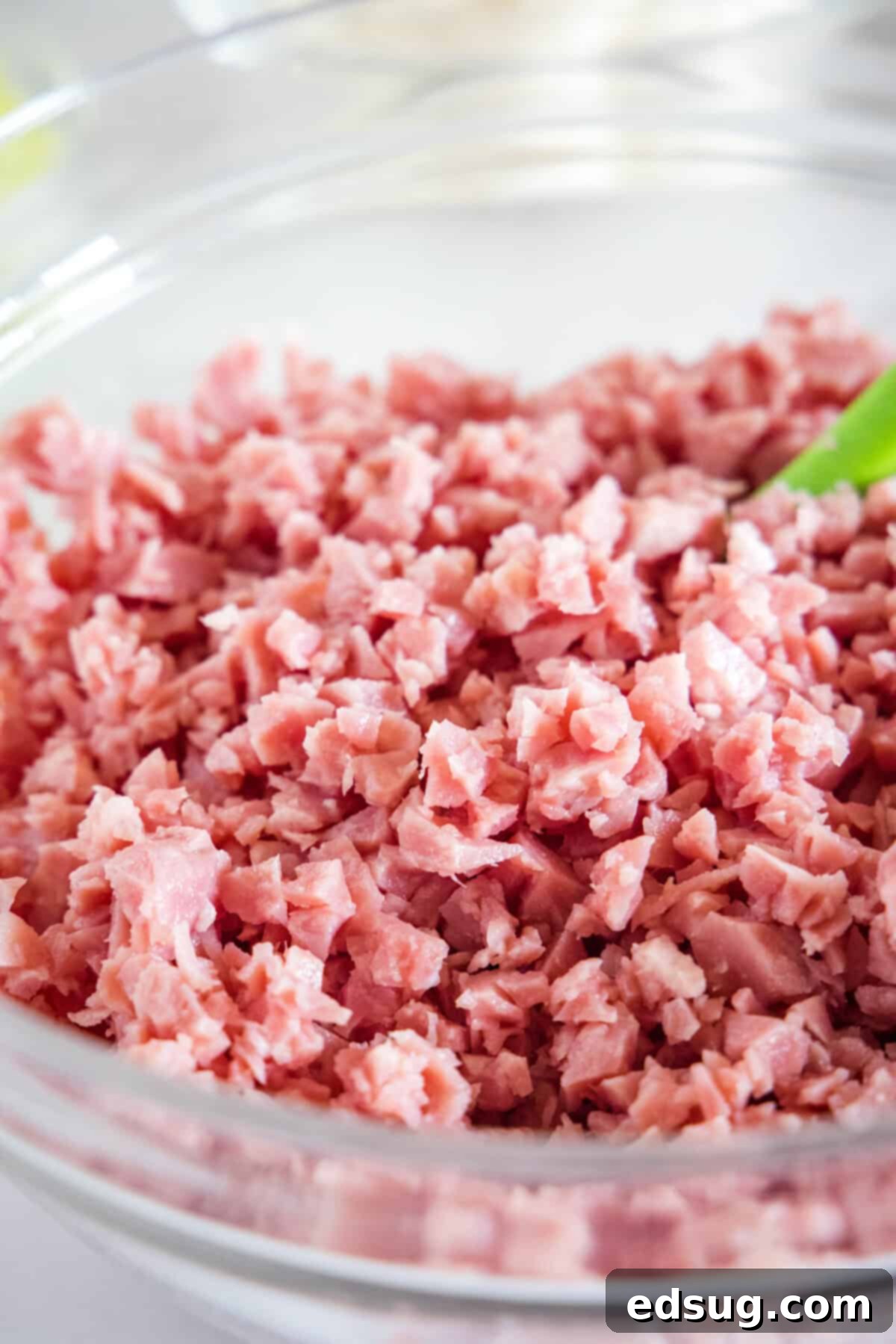 This ham salad recipe is the best way to use up leftover ham! It's similar to a chicken salad, with mayo, red onions, and juicy shredded ham. Finely chopped ham in a bowl.