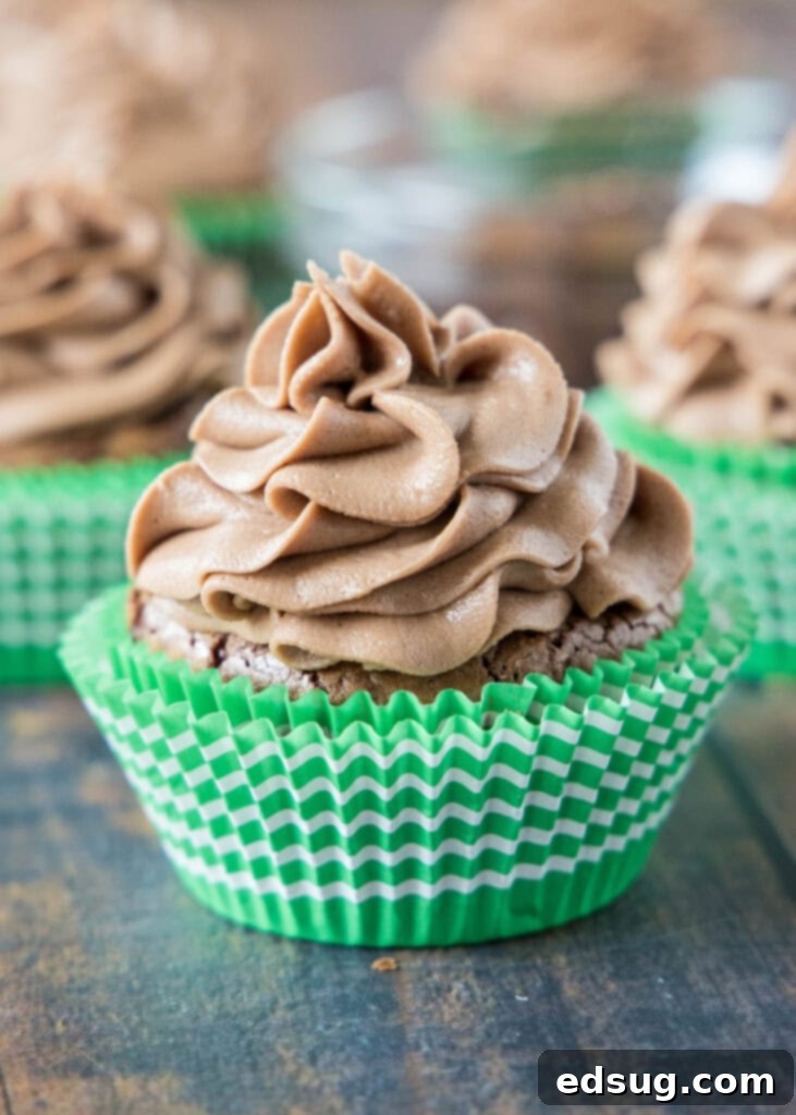 Decadent Nutella Cupcakes 2 Decadent chocolate Nutella cupcakes arranged on a rustic wooden table