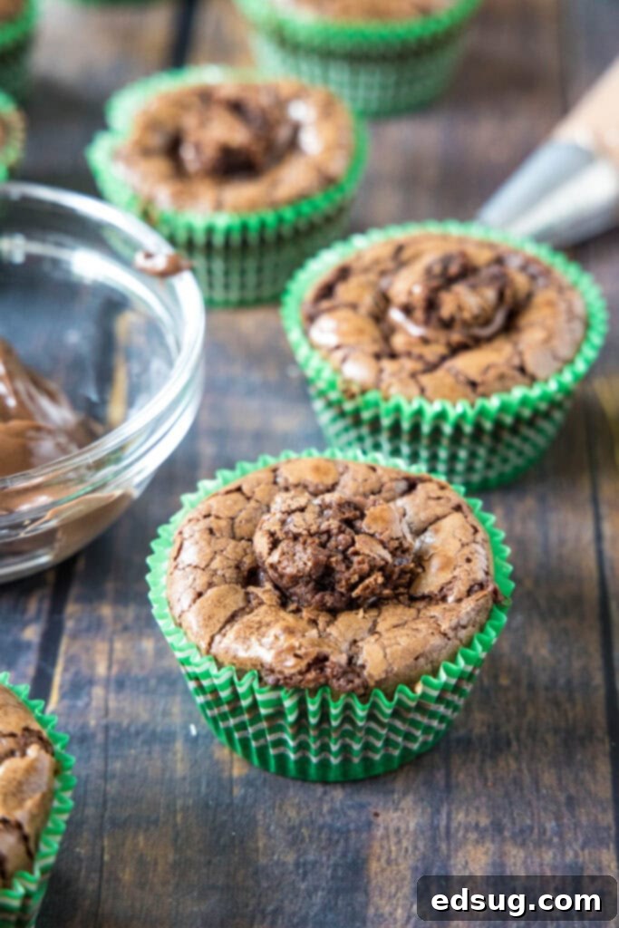 Decadent Nutella Cupcakes 4 Close-up view of cupcake batter being scooped into lined muffin cups